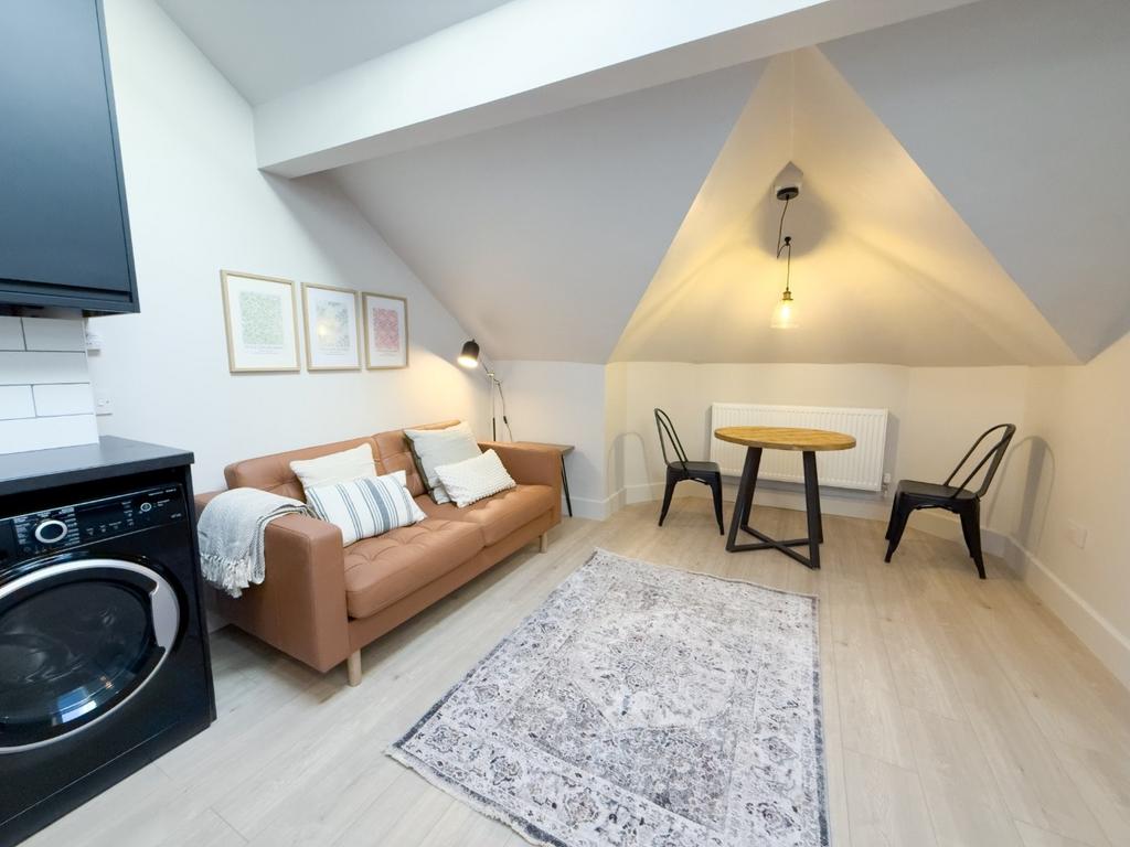 Bright, modern living area with a comfortable s...