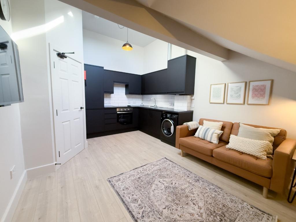 Bright, modern open-plan living area with a com...