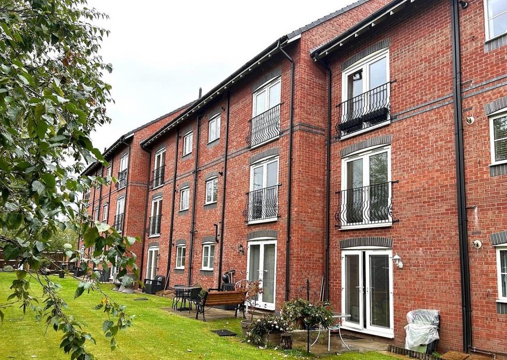 Well-maintained communal lawn and patio area be...