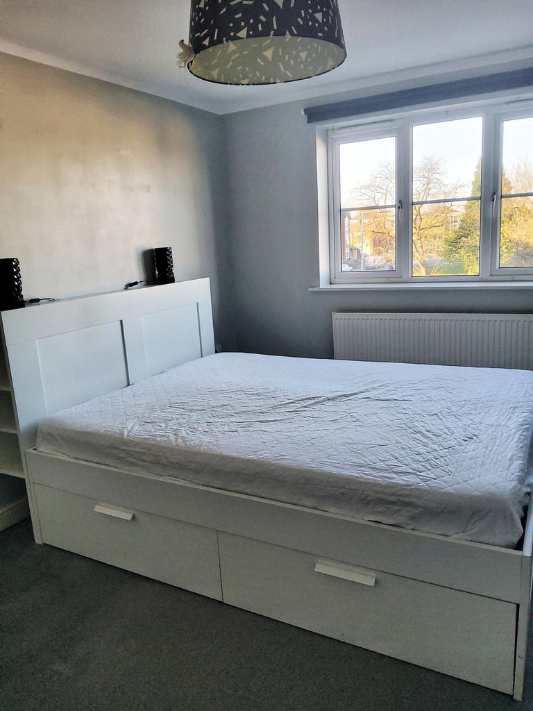 Bright, tidy furnished bedroom with a large whi...