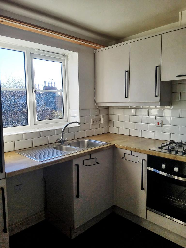 Bright, modern kitchen with a large window, whi...