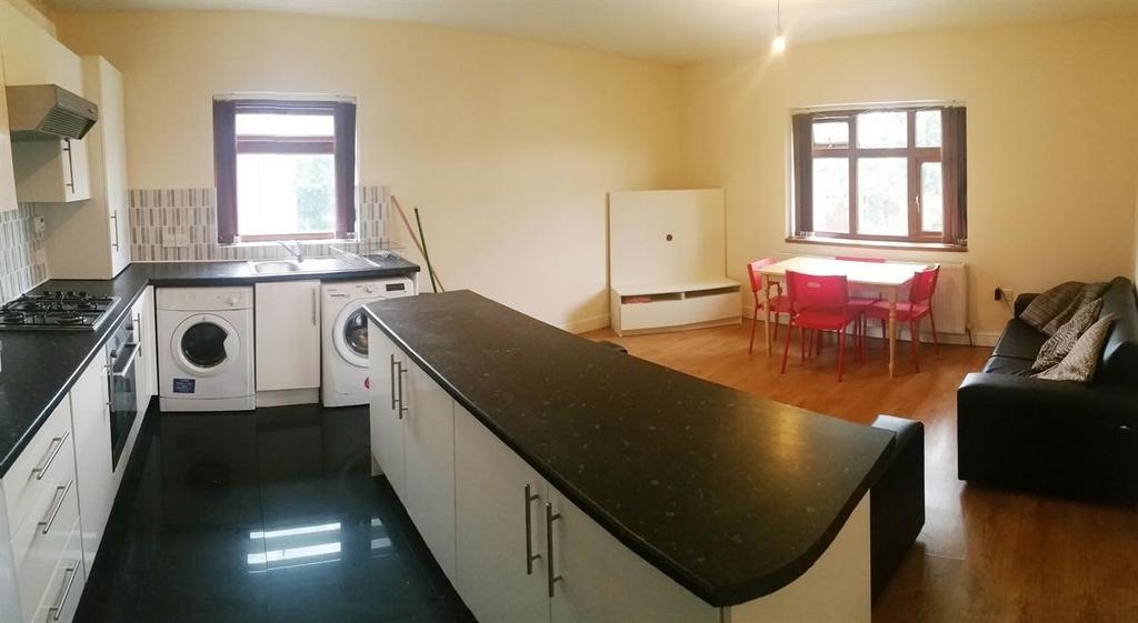 Bright open-plan kitchen and dining area with a...