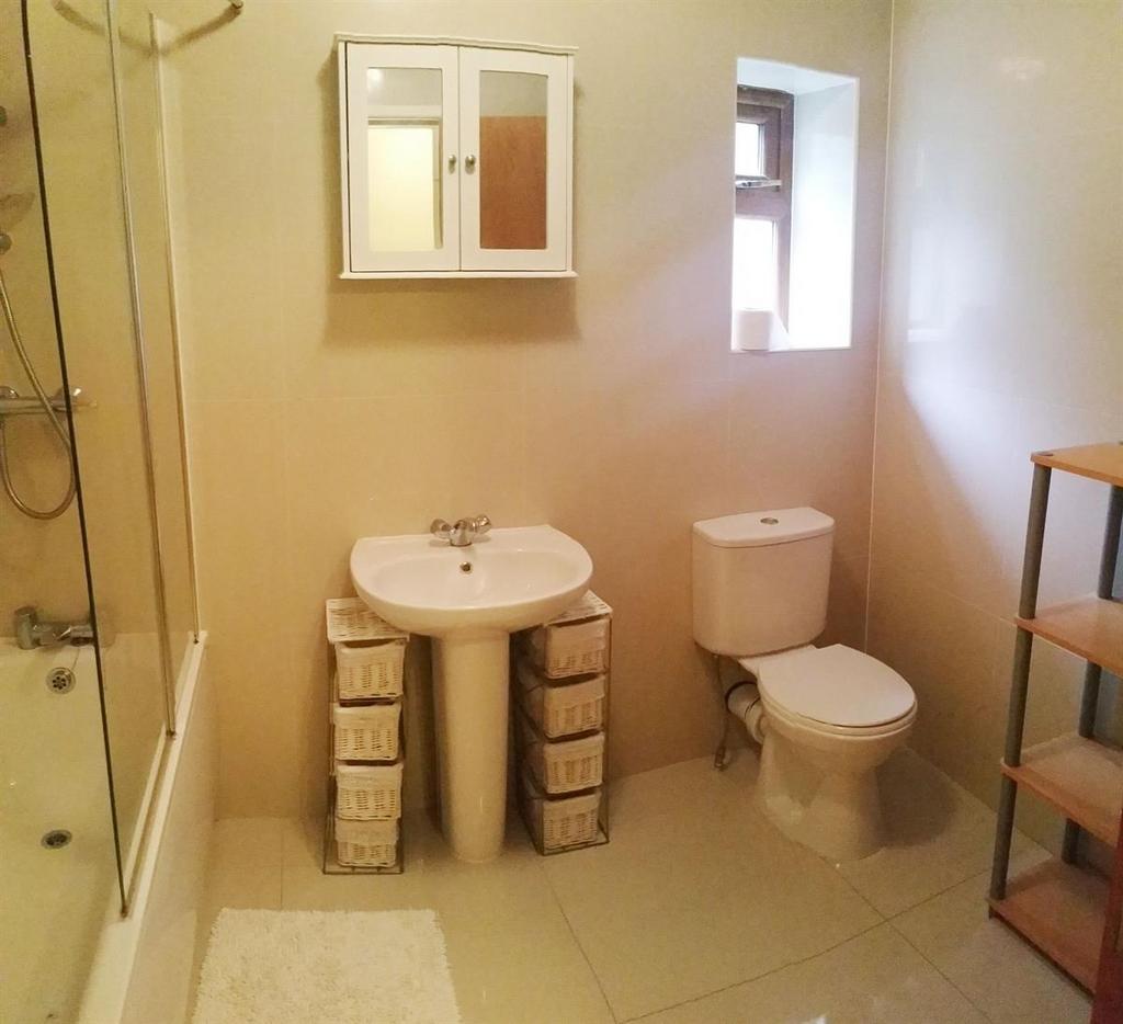 Bright, neutral bathroom with a pedestal sink, ...