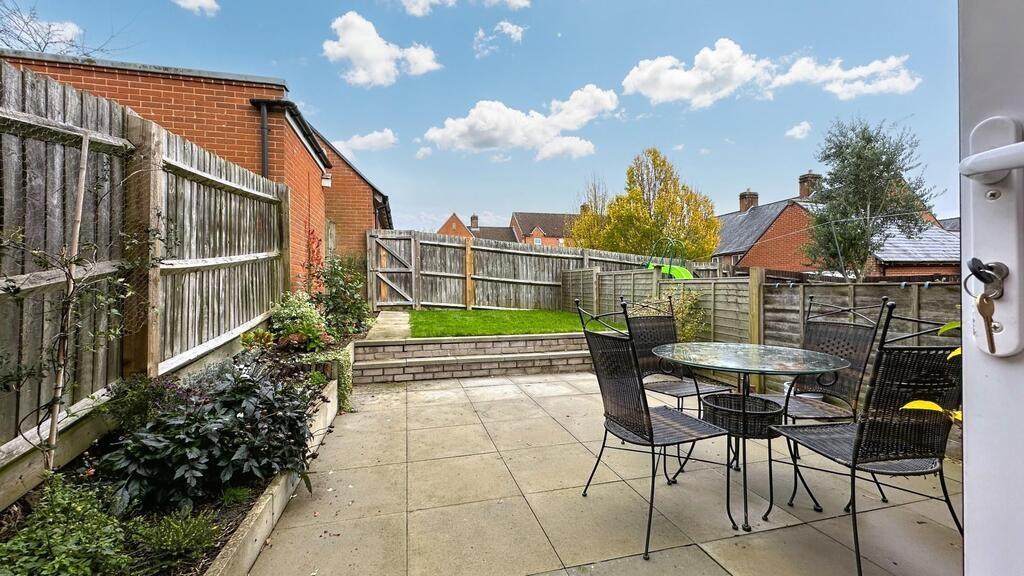 Sunny private rear garden with a paved patio, o...