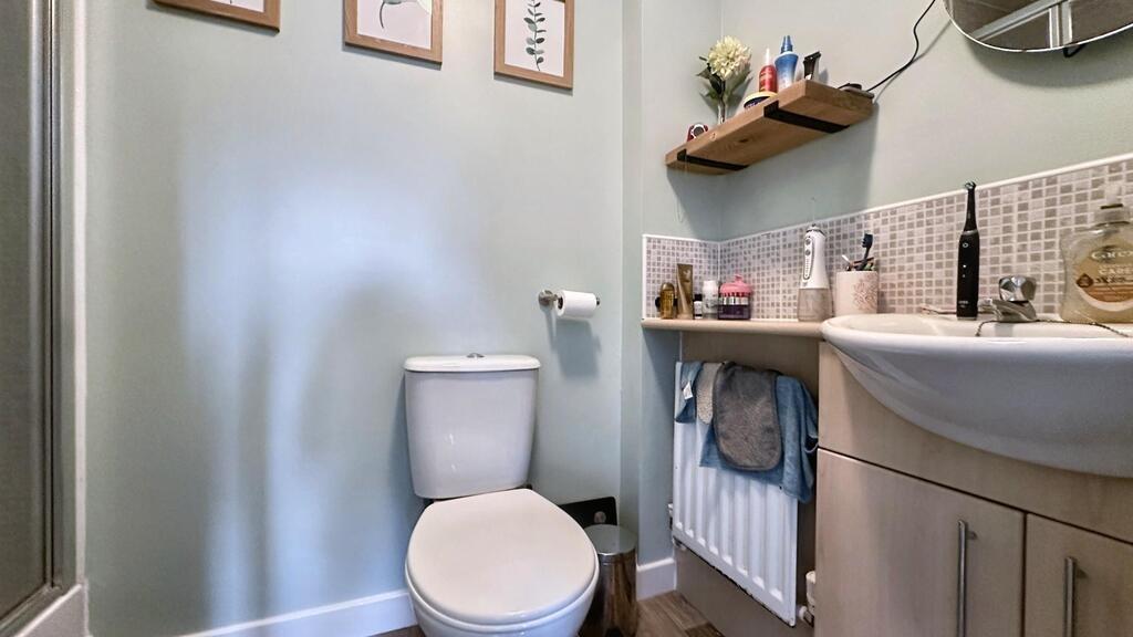 Neat and modern bathroom with a white toilet, v...
