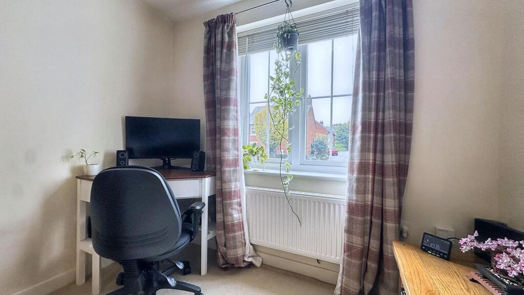 Cozy single bedroom with a large window letting...