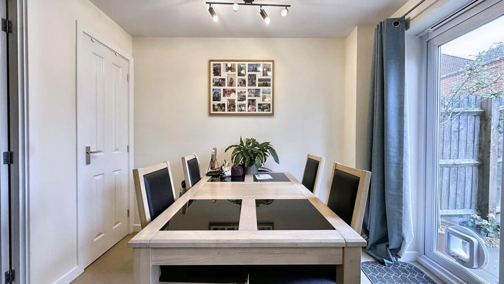 Bright, modern dining area with a large glass-t...