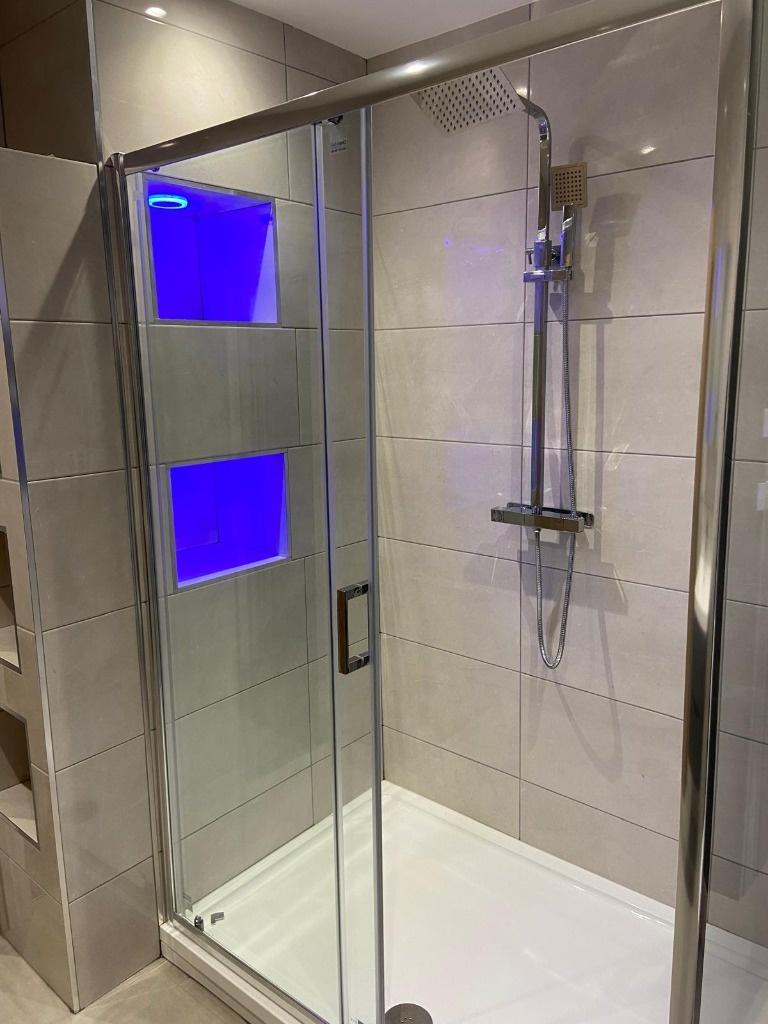 Modern tiled shower enclosure with frameless gl...