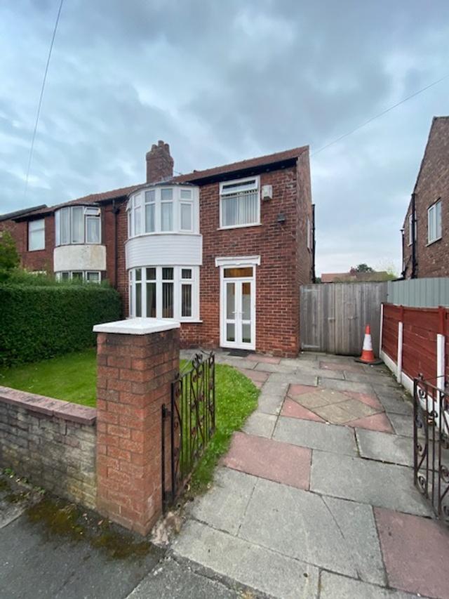 Traditional semi-detached brick home with a bay...
