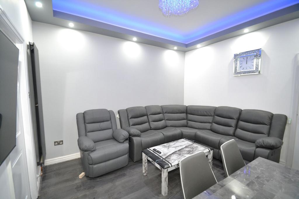 Modern and spacious living room featuring a lar...