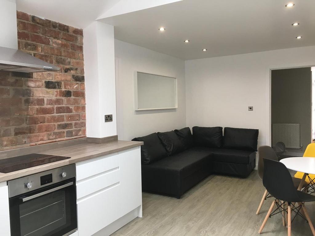 Modern open-plan living area with a fitted kitc...