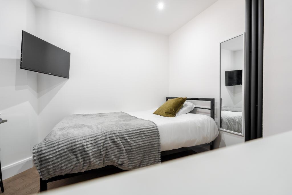 A bright and modern master bedroom featuring a ...