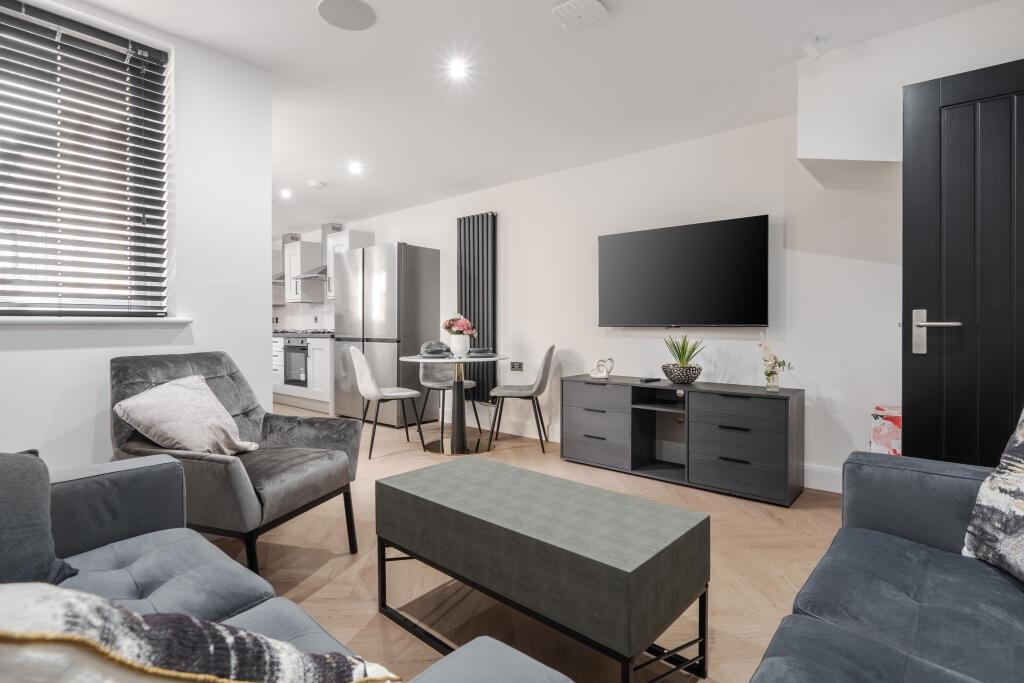 A modern, spacious living room featuring stylis...