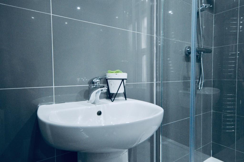 A clean and modern bathroom with a large bath a...