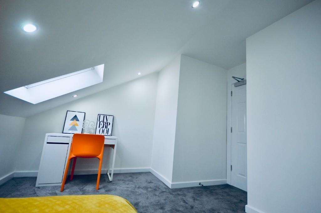 A clean and bright bathroom with a spacious lay...