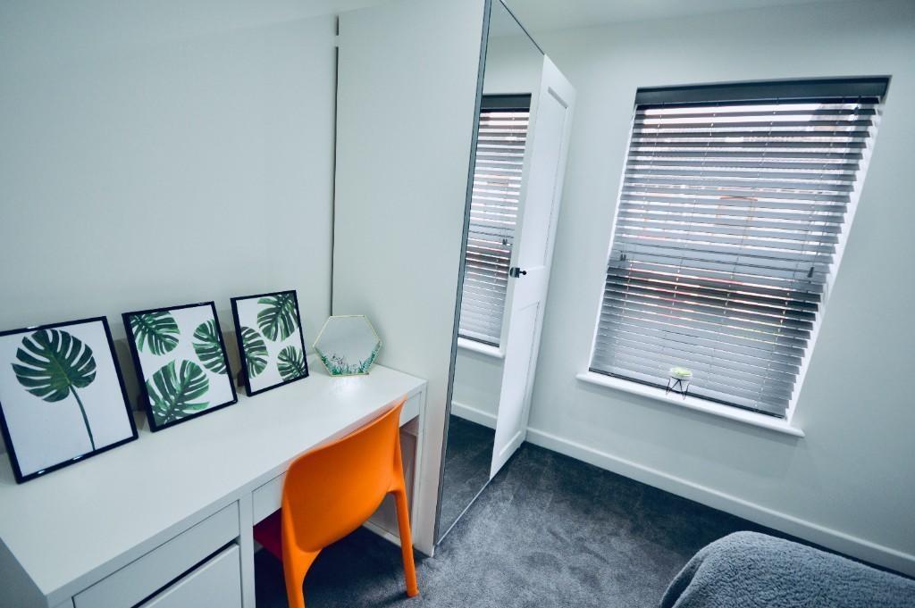 A bright, well-maintained room featuring two wi...