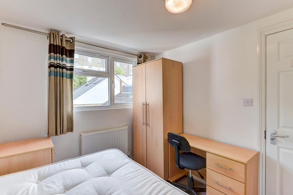 Bright, tidy bedroom with a comfortable bed, st...