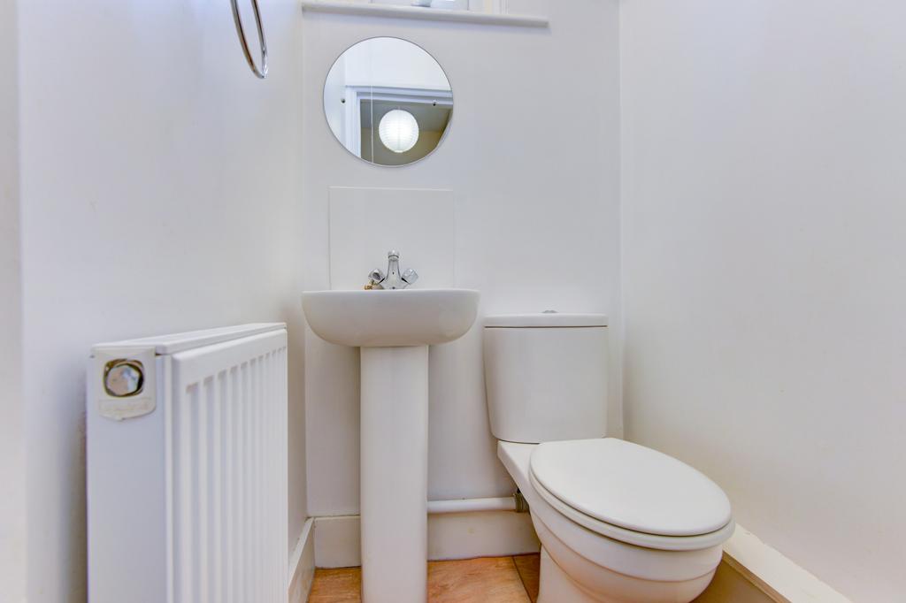 Bright, well-maintained WC with a pedestal sink...