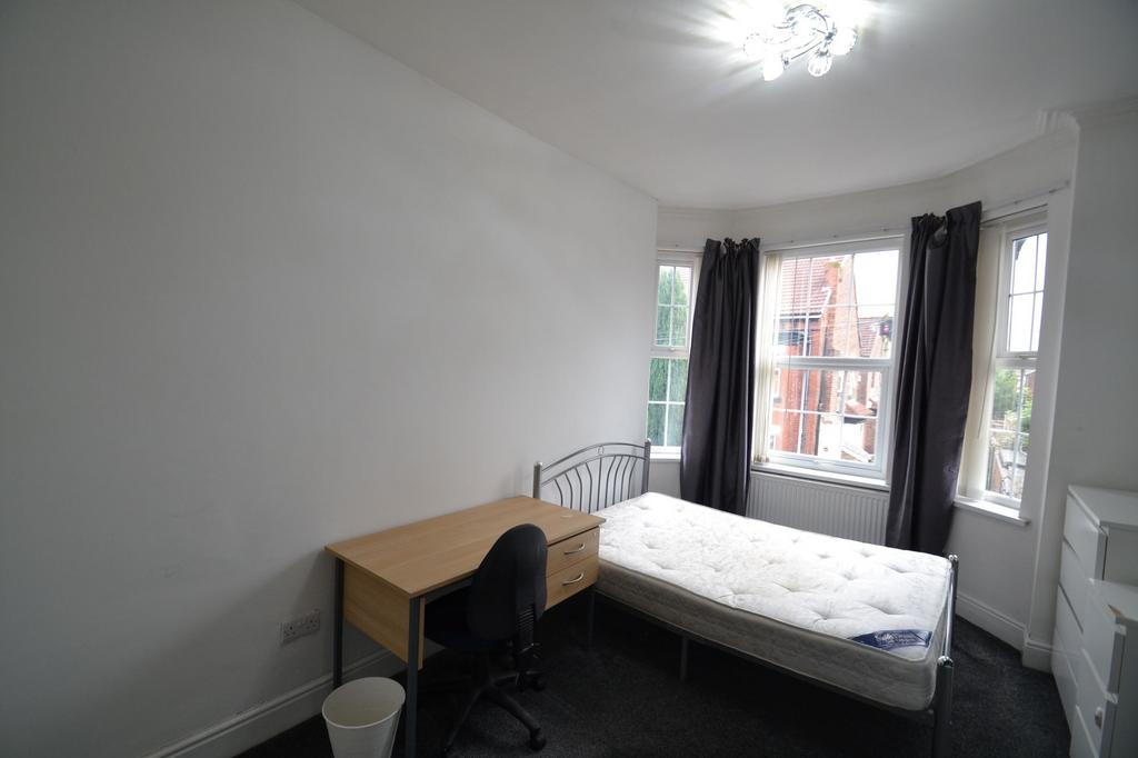 A bright, well-maintained bedroom featuring a s...