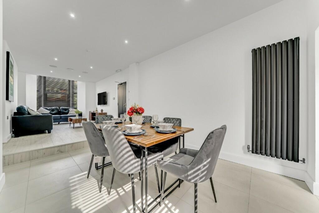 A spacious and modern living room featuring a c...