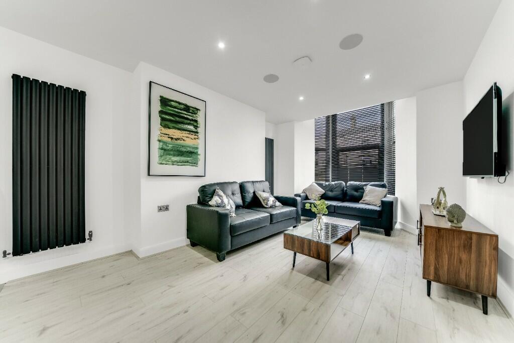 Modern, spacious living room with large windows...