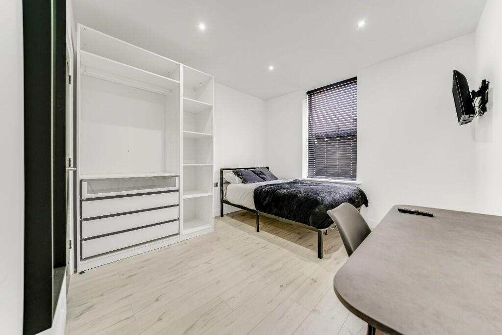 Bright and modern master bedroom featuring a st...