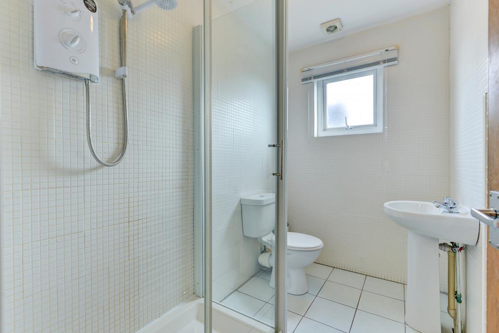 Bright, well-maintained bathroom with a corner ...