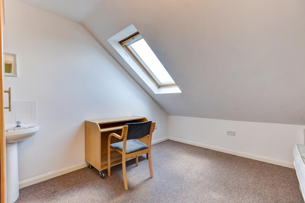 Bright attic single bedroom with a skylight win...