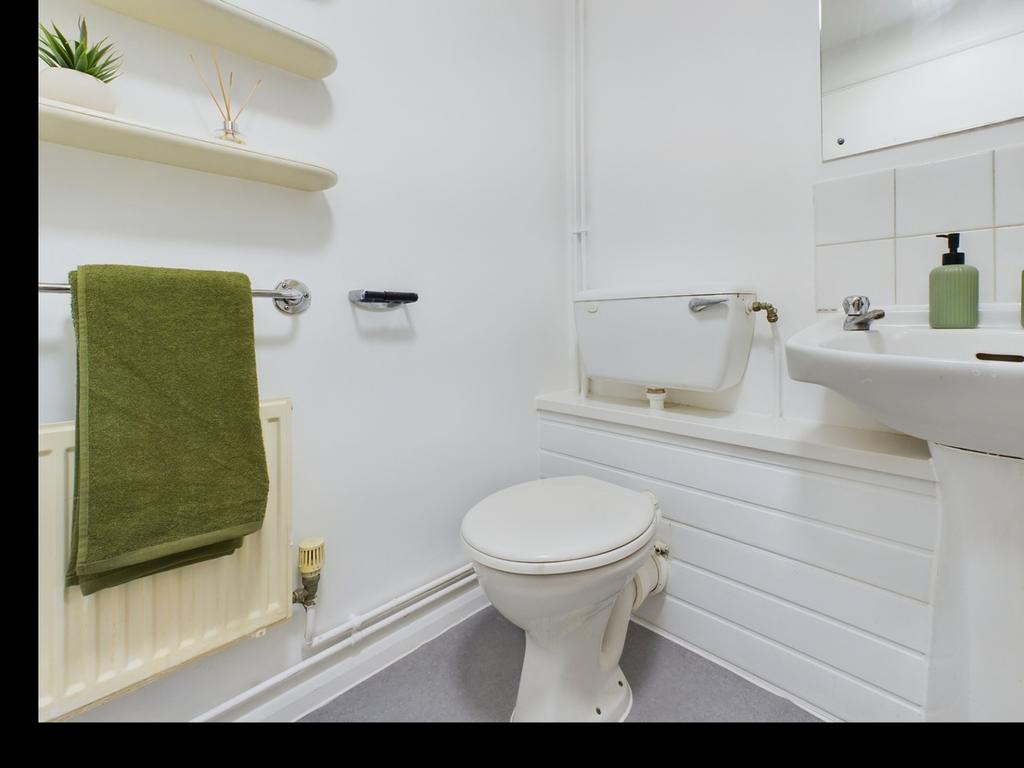 A tidy and well-maintained single toilet with m...