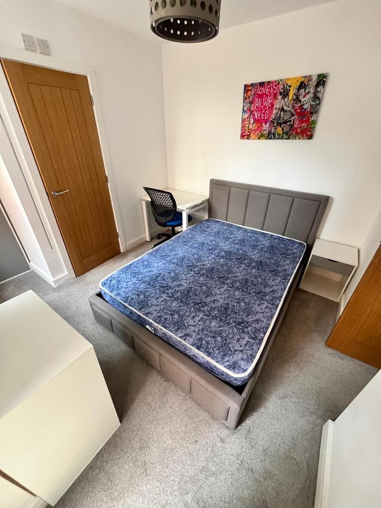 Bright, modern bedroom with a comfortable doubl...