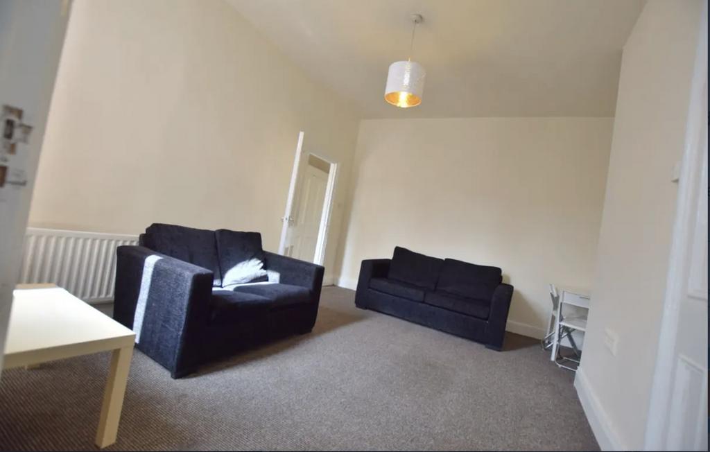 Bright, neutrally decorated living room with tw...