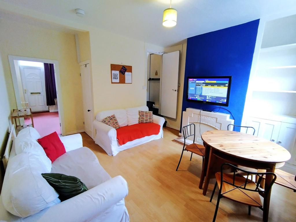 Bright, modern living/dining room with two whit...