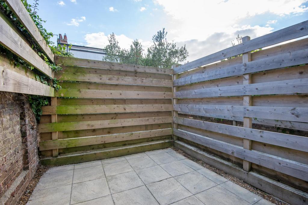 Private paved patio area with timber fencing of...