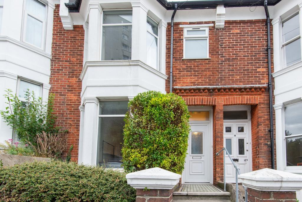 A charming front exterior of a traditional terr...