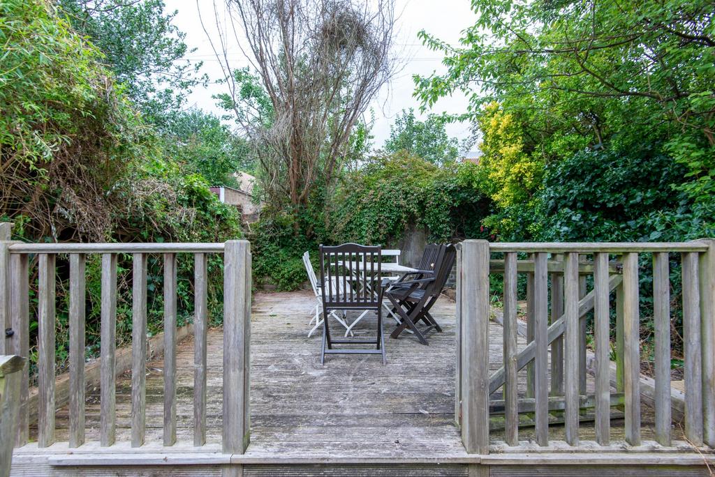 Sunny private garden with a wooden deck, outdoo...