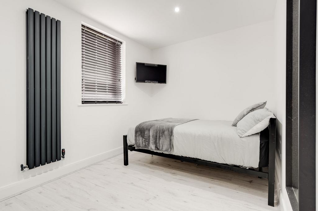 A modern, well-maintained bedroom featuring a d...