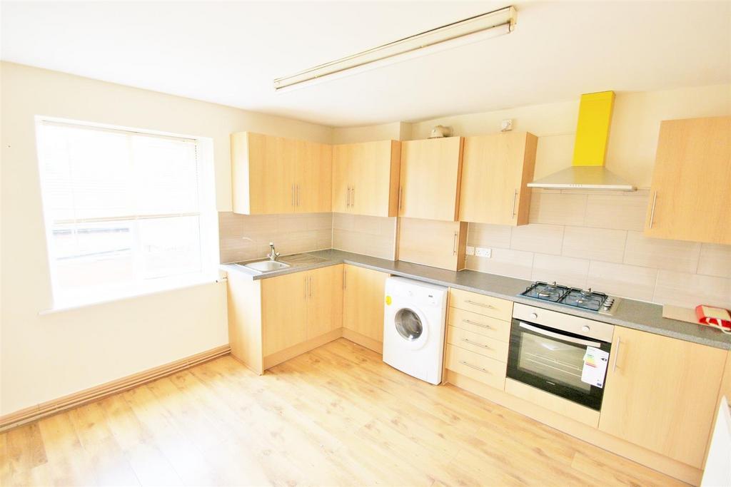 Bright, tidy kitchen featuring ample cabinetry,...