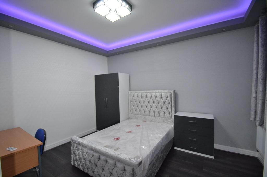 Modern double bedroom with a plush upholstered ...