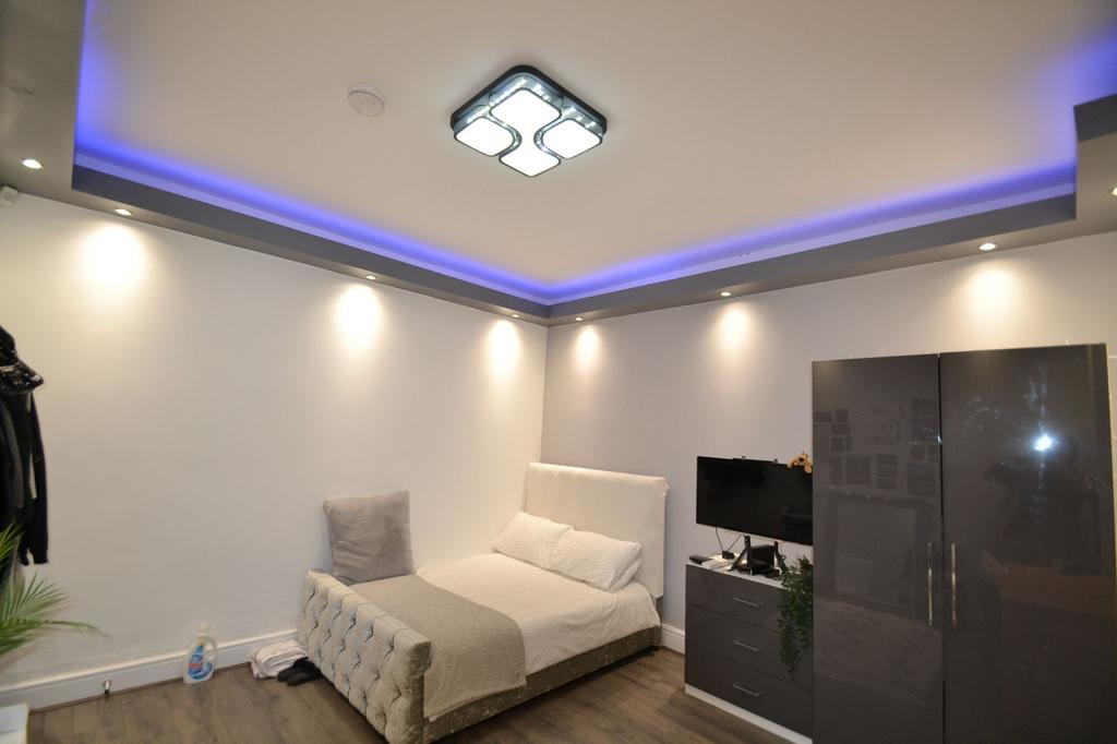 Modern double bedroom with stylish recessed cei...