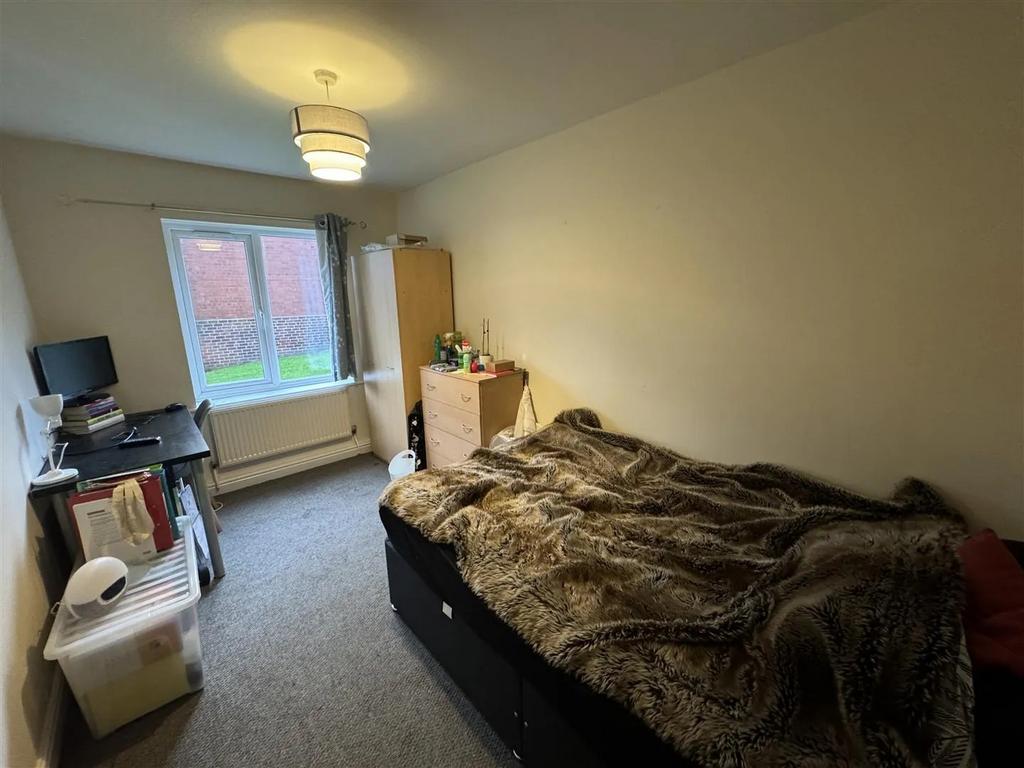 A comfortable bedroom featuring a large double ...