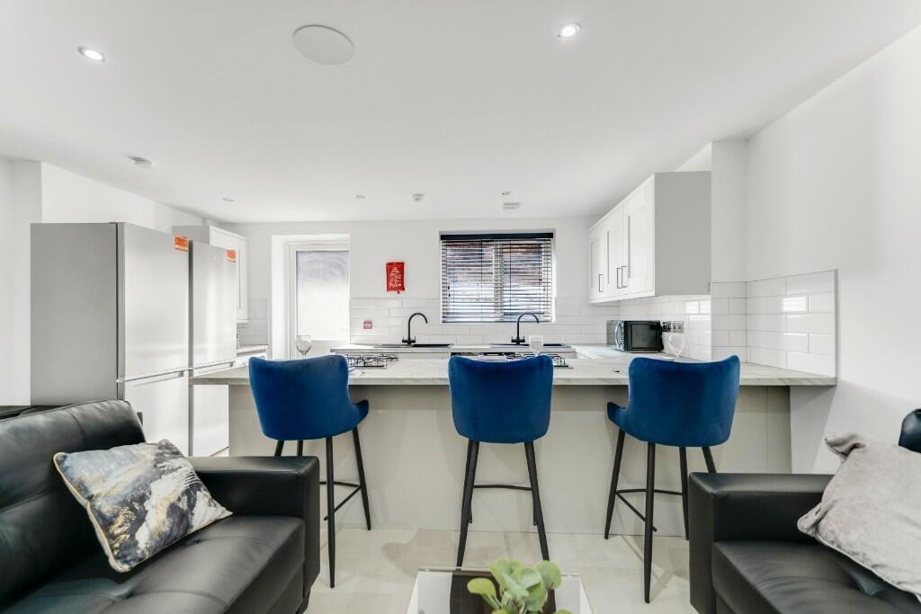 Modern and well-lit living area featuring comfo...