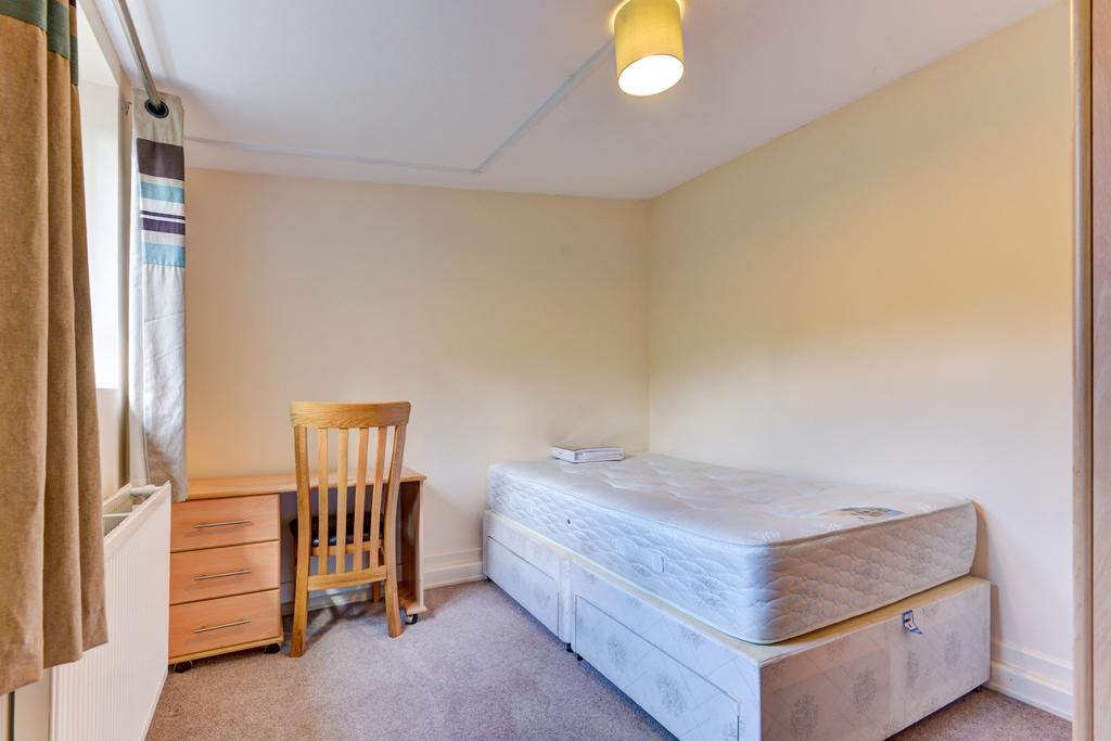 A cozy and neat single bedroom featuring a comf...