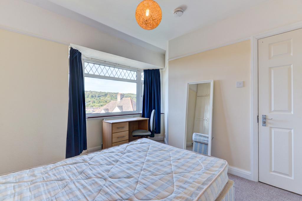 Bright, neatly presented bedroom with a large w...