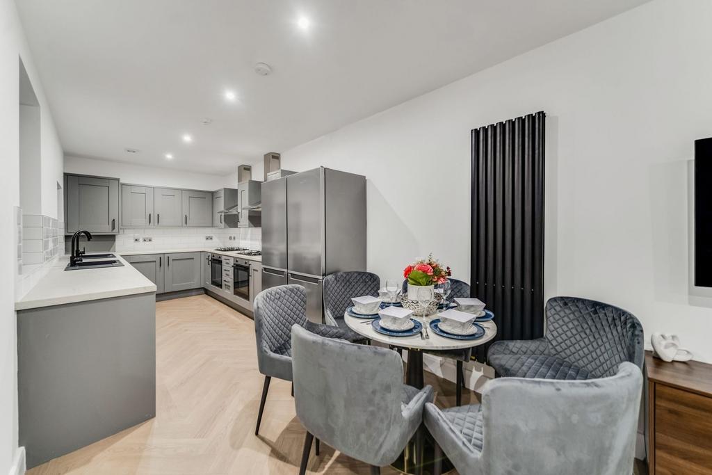 A modern, stylish kitchen with sleek gray cabin...