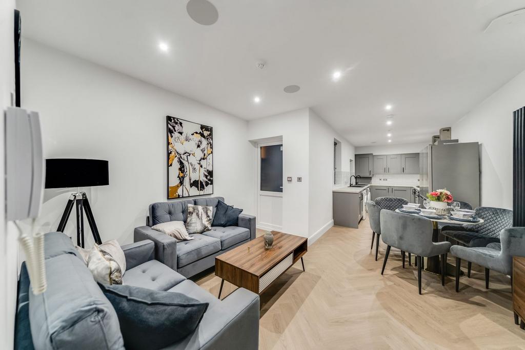 Modern and spacious living room featuring comfo...