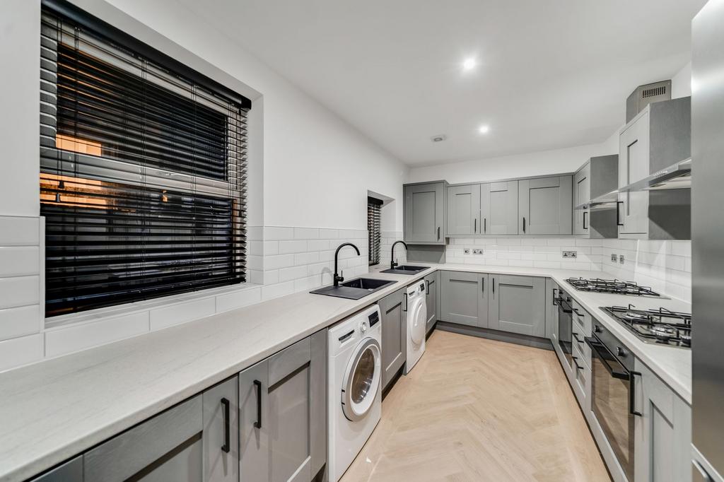 Contemporary kitchen featuring sleek grey cabin...