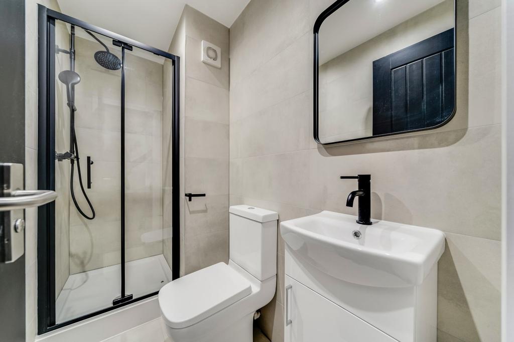 Modern, clean bathroom with a shower enclosure,...