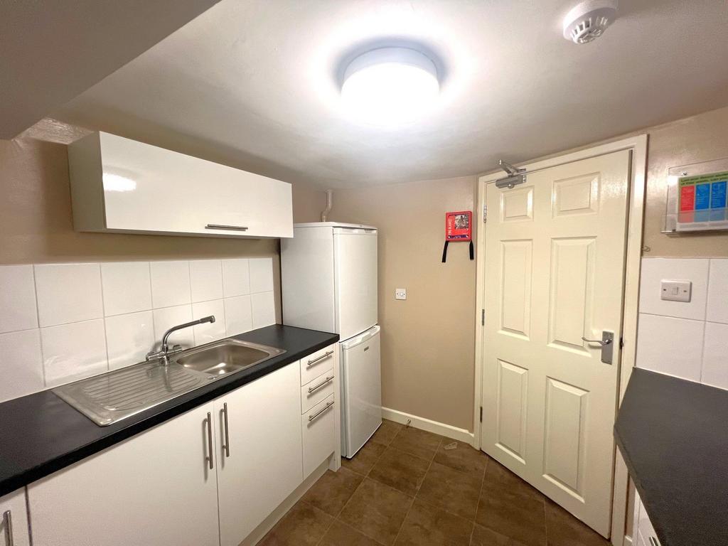A compact, functional kitchen area featuring a ...