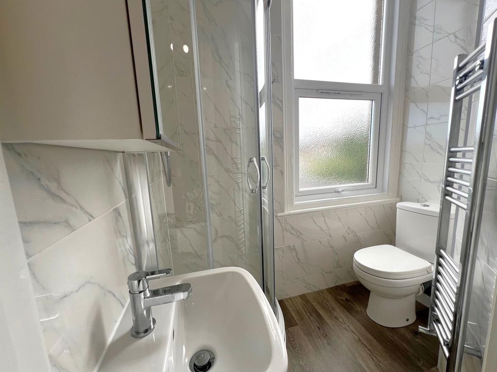 Bright, modern bathroom with a corner shower, c...