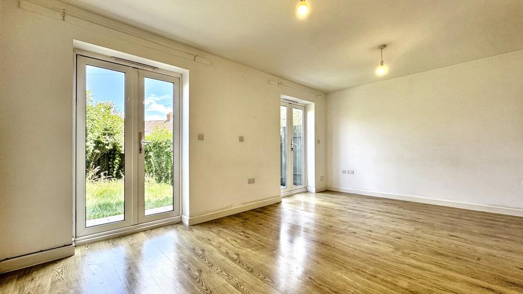 Bright, airy living room with wooden floors, fr...